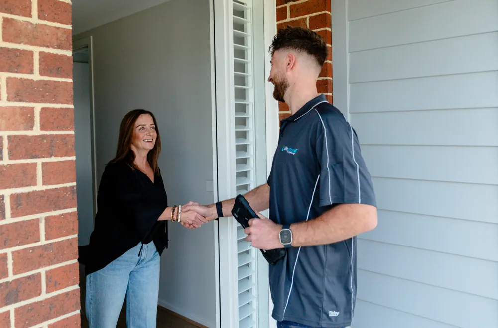 LifeProof roof plumber greeting a homeowner at her front door