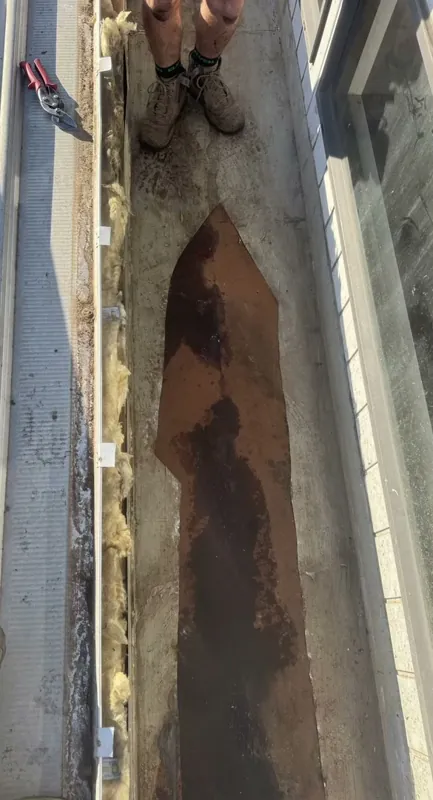 Old box gutter rusted through along its base