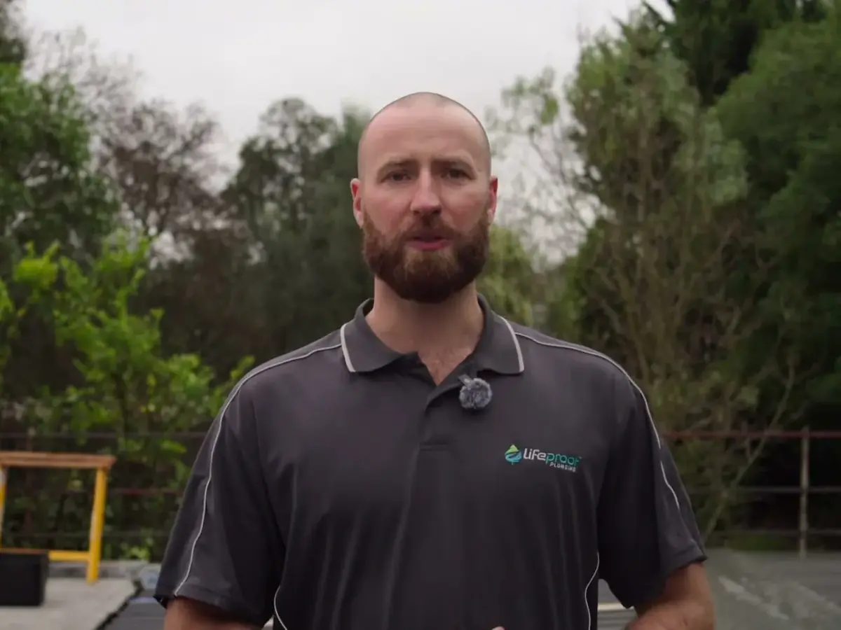 Ryan Lord, owner of LifeProof Roofing, standing on a roof