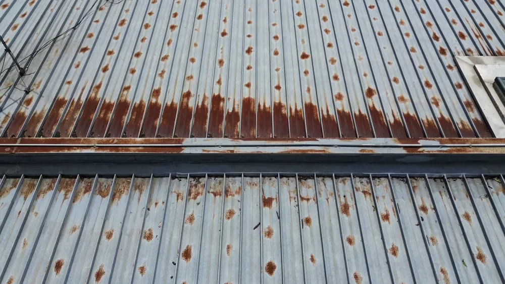 Rusted metal roof sheets meeting at a joint