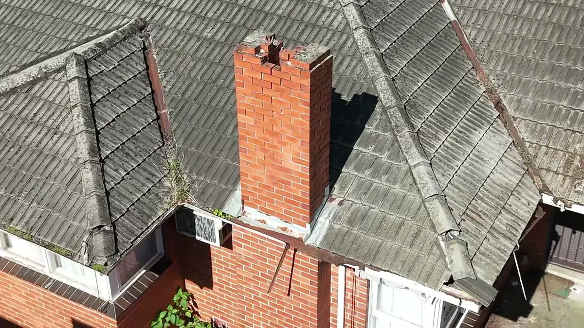 Concrete tile roof with a brick chimney, seen from above
