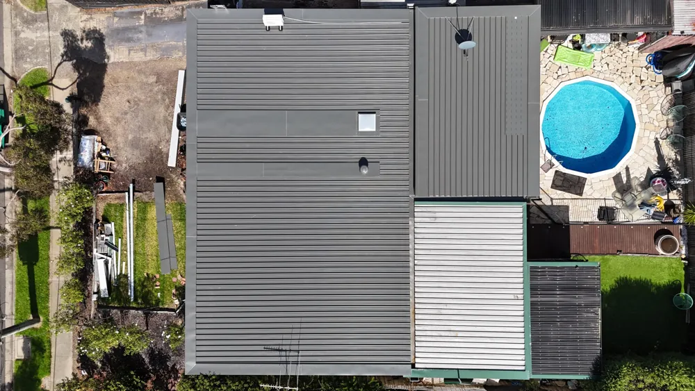 New Colorbond roof from above, beside a backyard pool