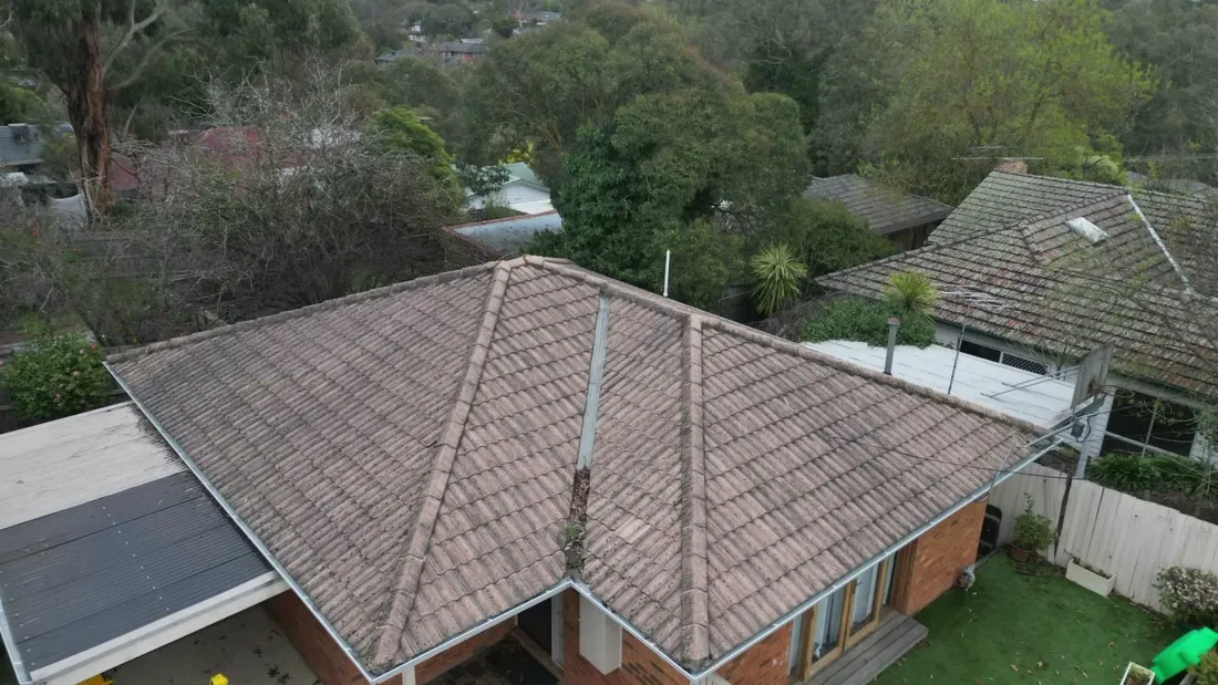 Faded, weathered concrete tile roof before restoration