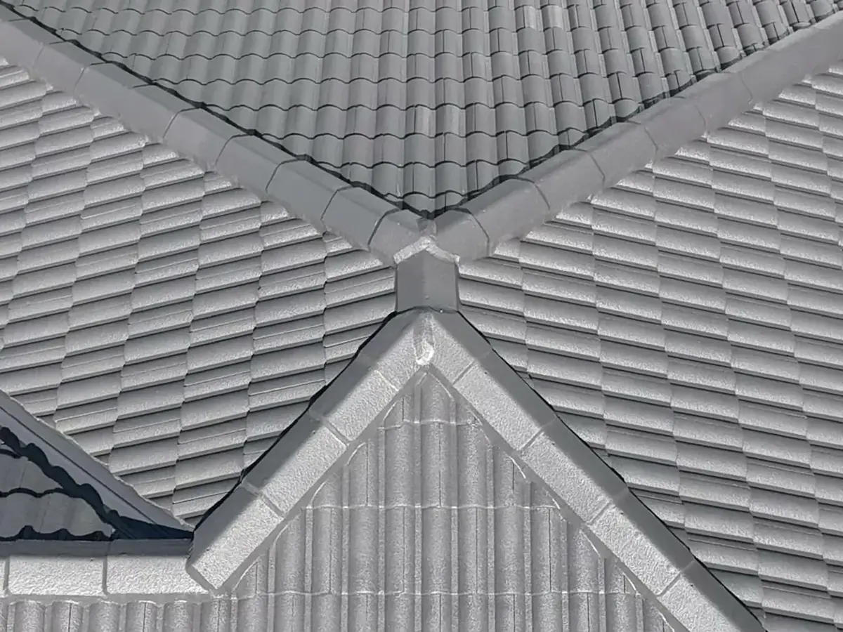 Restored concrete tile roof with freshly repointed ridge capping