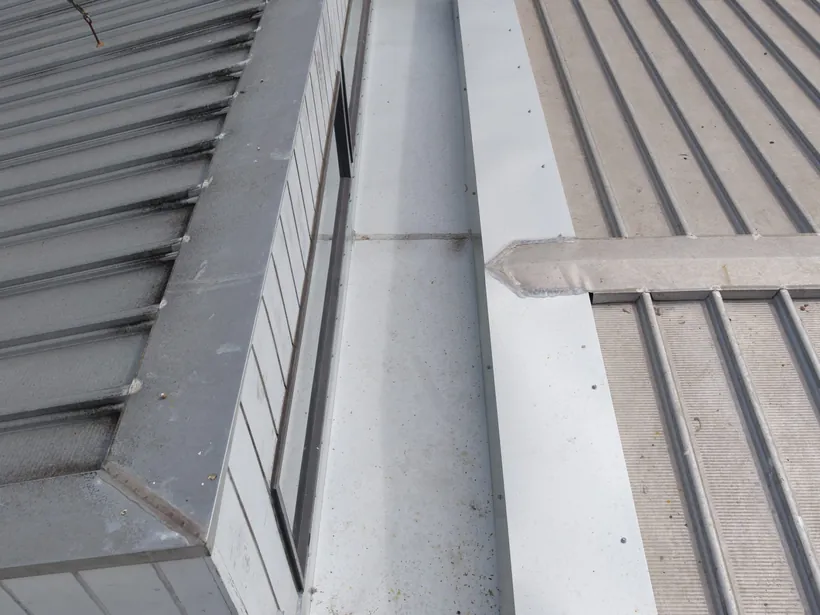 Box gutter and flashing on a metal roof from above